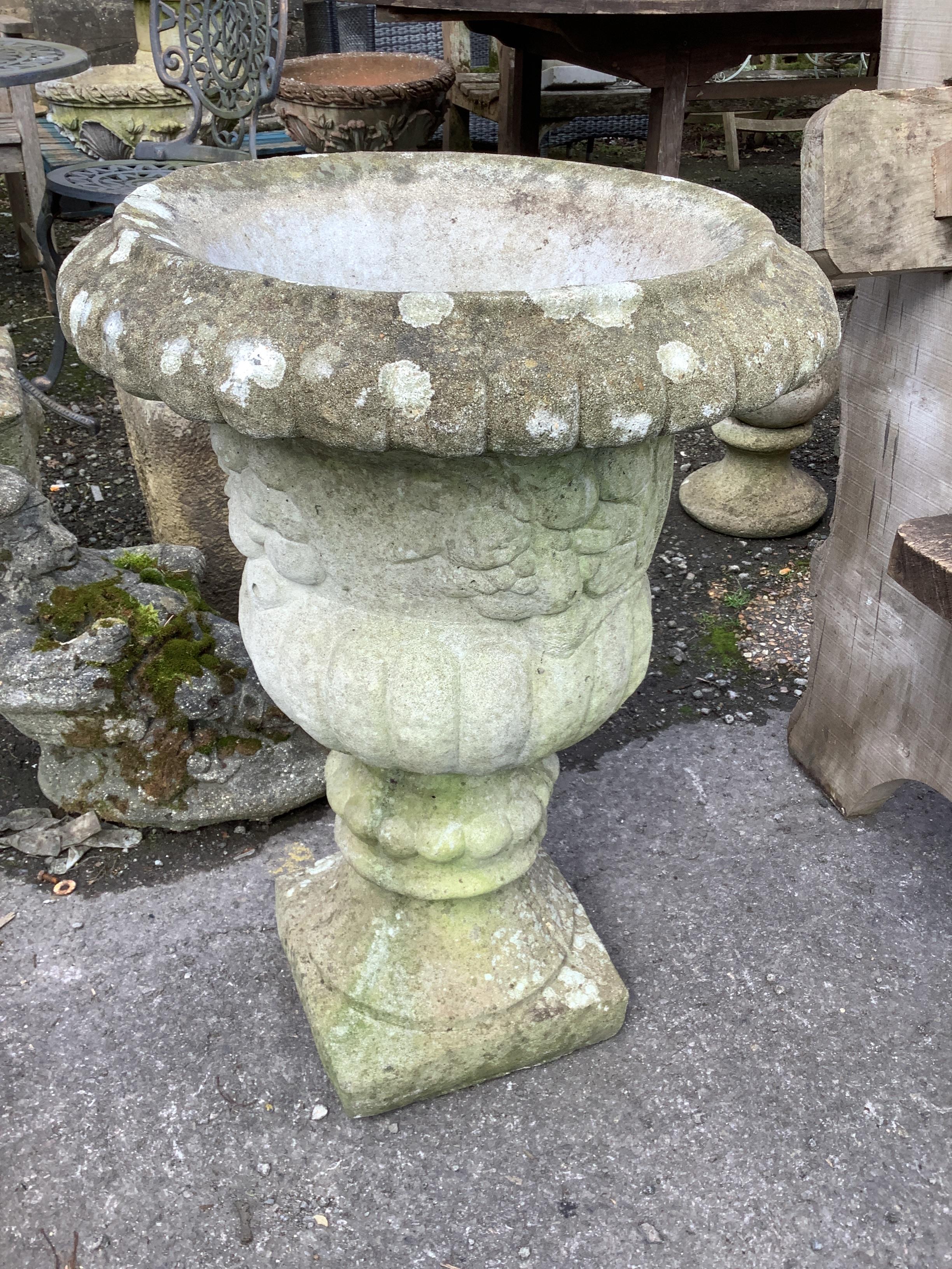 A reconstituted stone campana garden urn, diameter 47cm, height 68cm